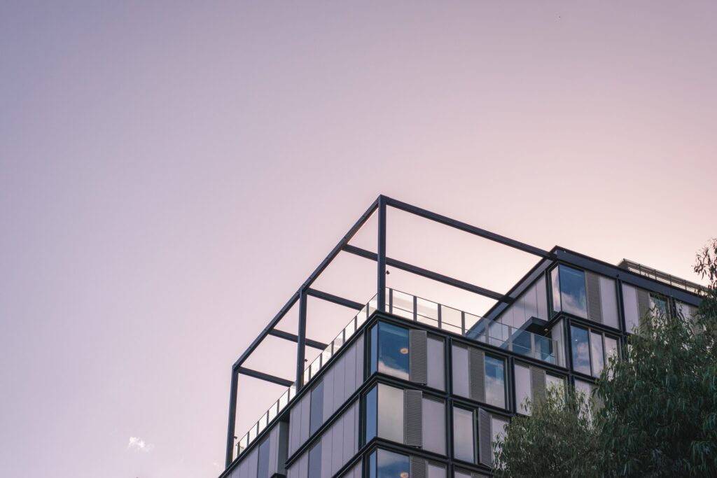 A modern apartment building under a twilight sky highlights Fortum Digital's expertise in presenting real estate through advanced digital marketing and 3D virtual tours, showcasing the pinnacle of contemporary property management solutions.